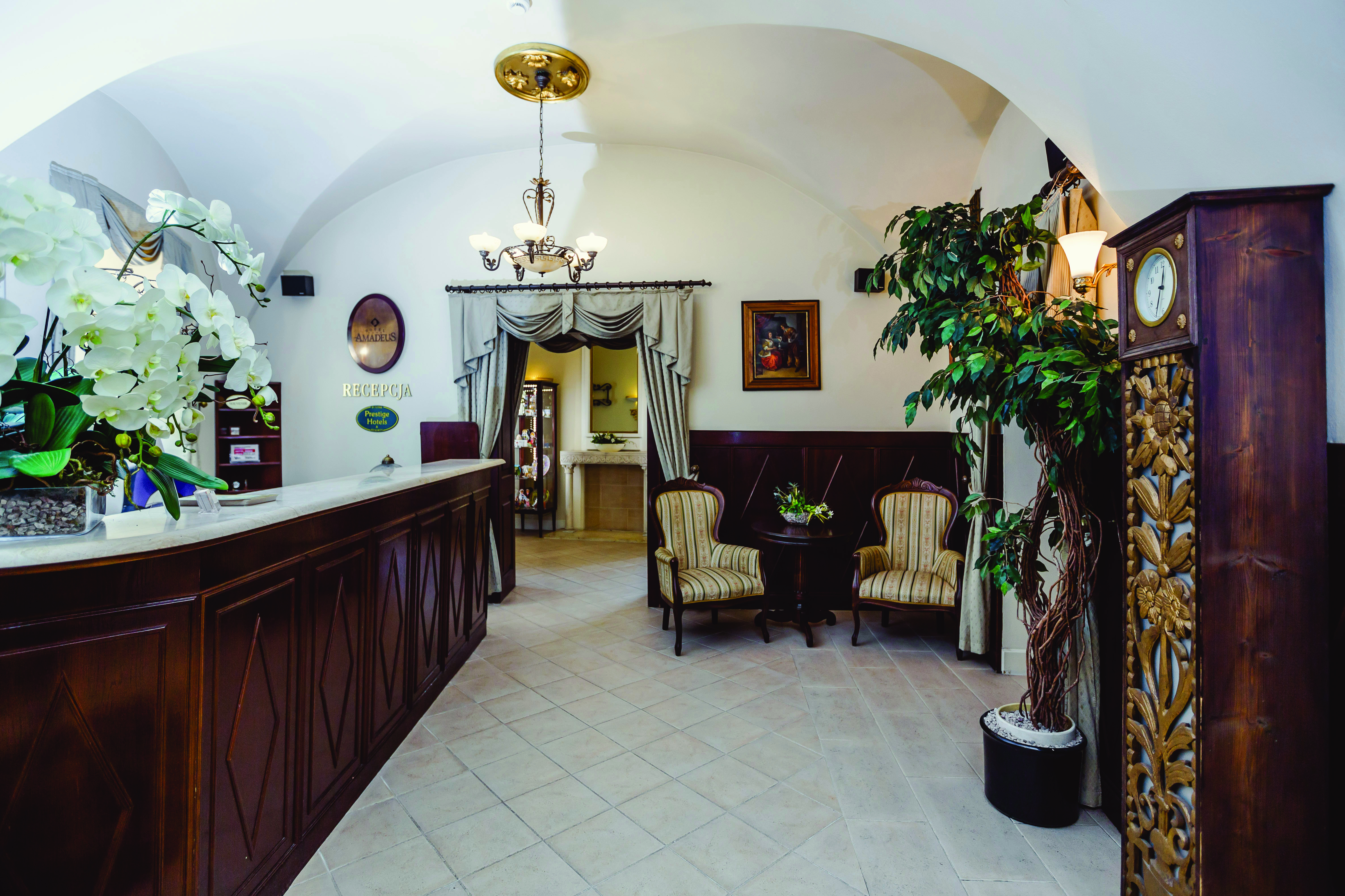 Hotel lobby with wooden reception desk and seating areas