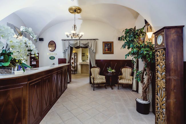 Hotel lobby with wooden reception desk and seating areas