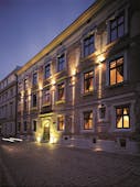 Hotel Copernicus Krakow exterior stone building with large windows and an arched entrance