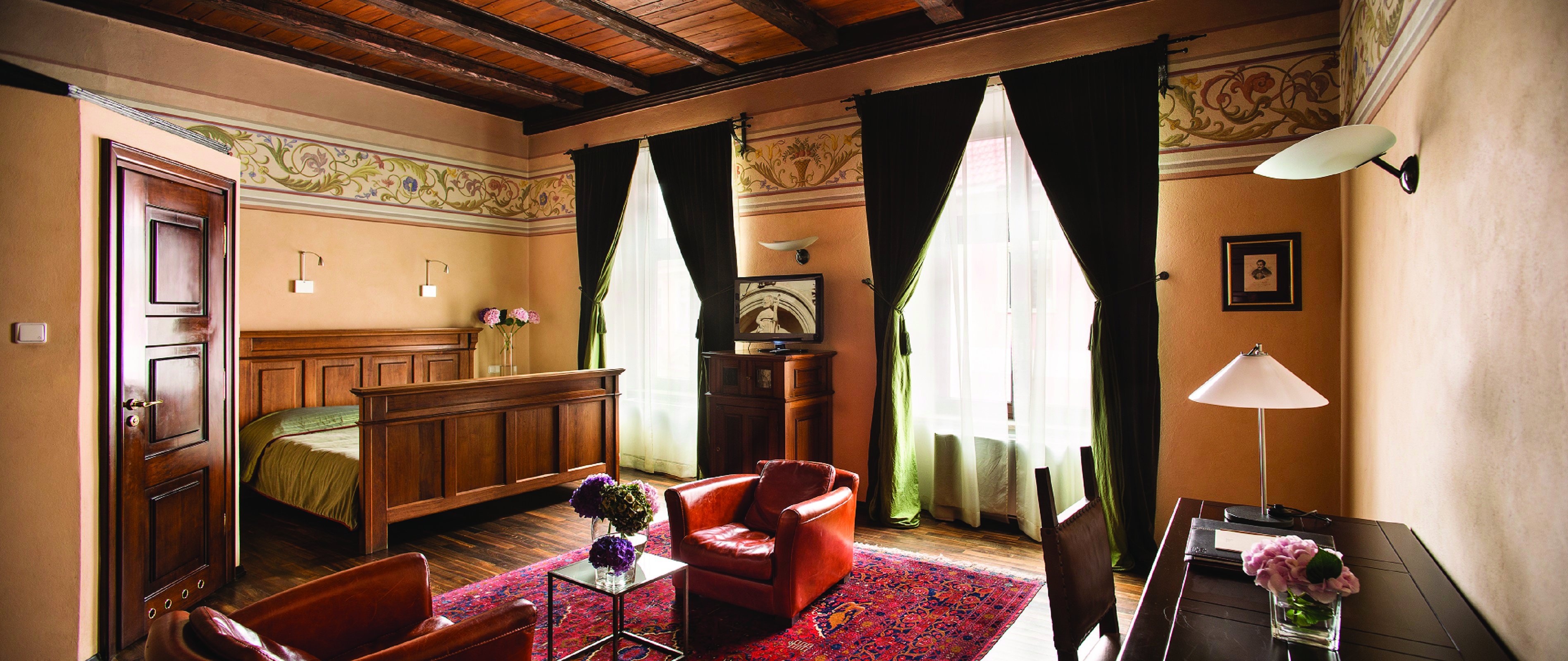 Hotel Copernicus Krakow luxury double bedroom wooden ceiling  leather chairs two large windows