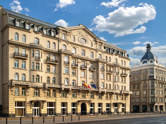 Polonia Palace Hotel exterior from the front with a large building and lots of small arched windows