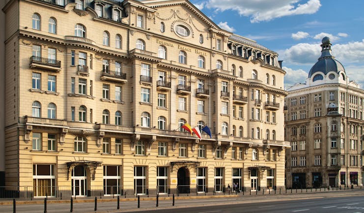 Polonia Palace Hotel exterior from the front with a large building and lots of small arched windows