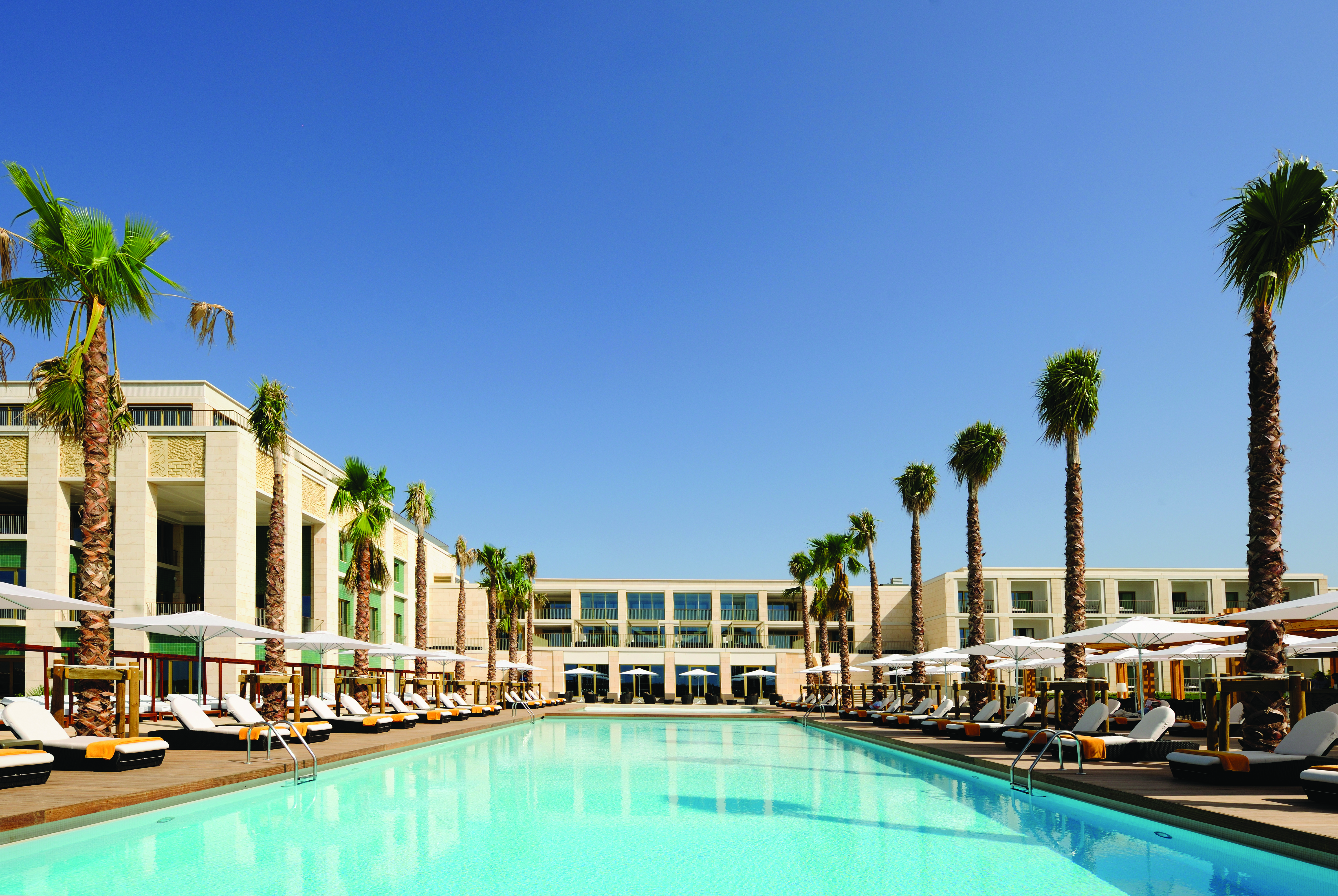 Anantara Vilamoura Portugal outdoor pool with sun loungers and umbrellas