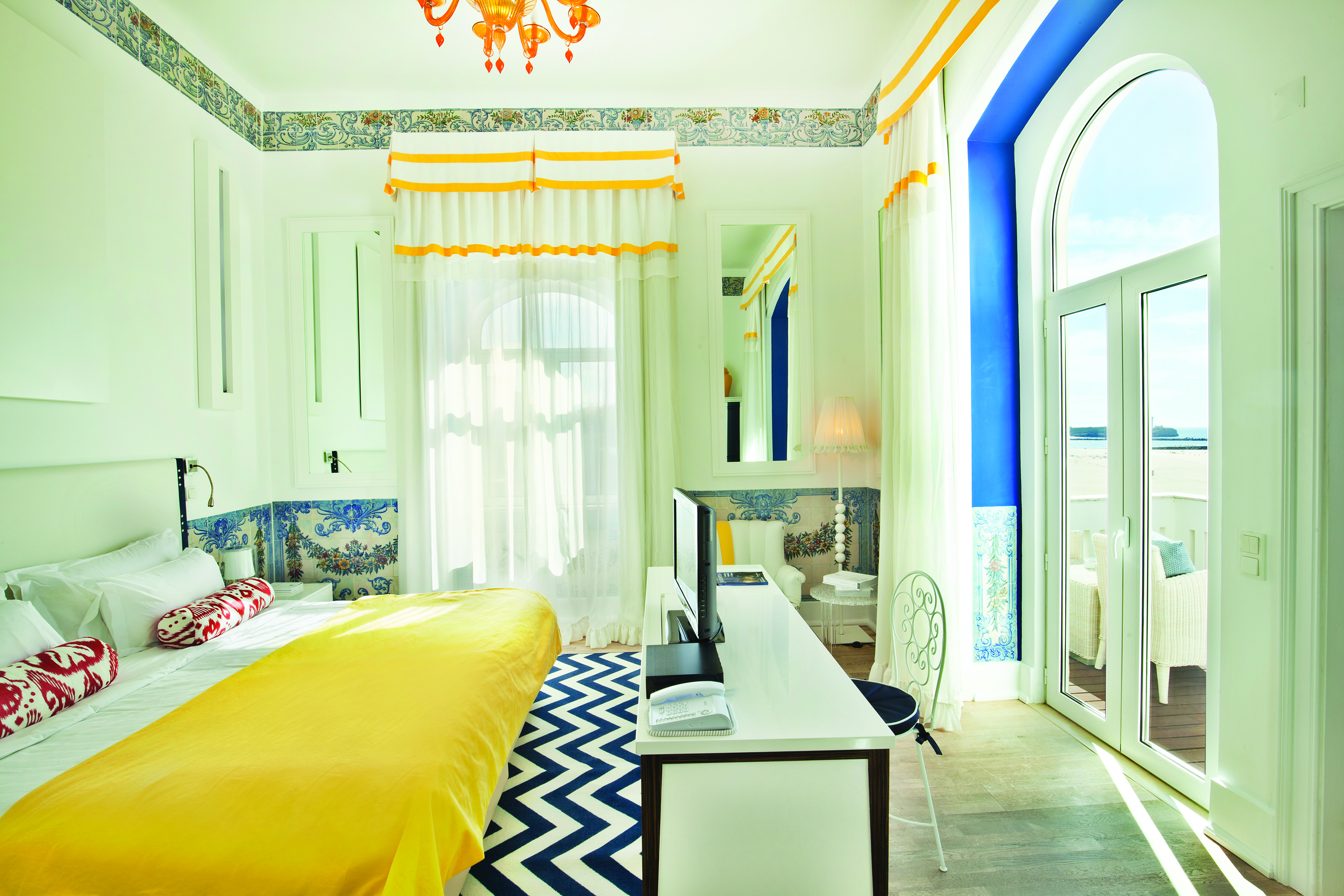 View of a Character Room at the Bela Vista Hotel & Spa with a double bed, television and large double doors opening onto a balcony