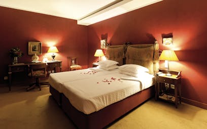 Executive room with red colour scheme, red walls and bed