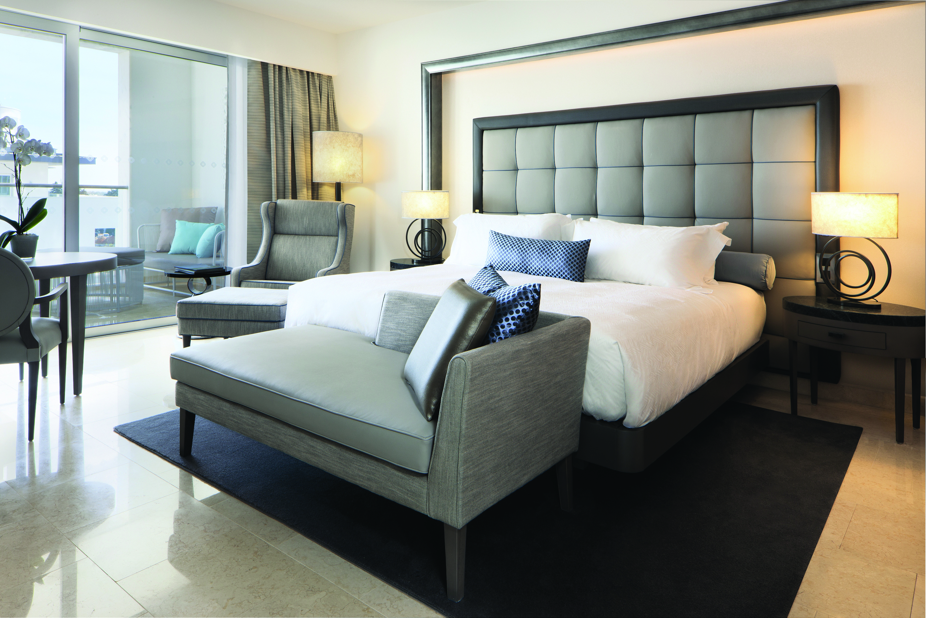 Conrad Algarve deluxe room, bed armchair, bright modern decor, balcony