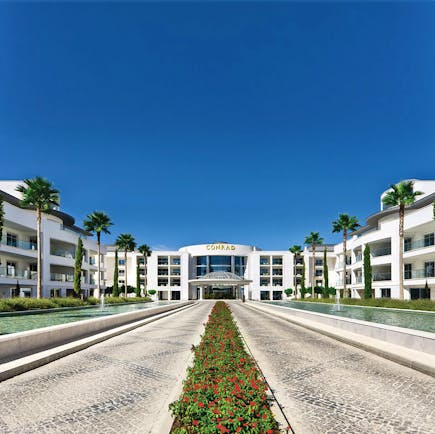 Conrad Algarve entrance, pathways leading to hotel door, fountains on each side