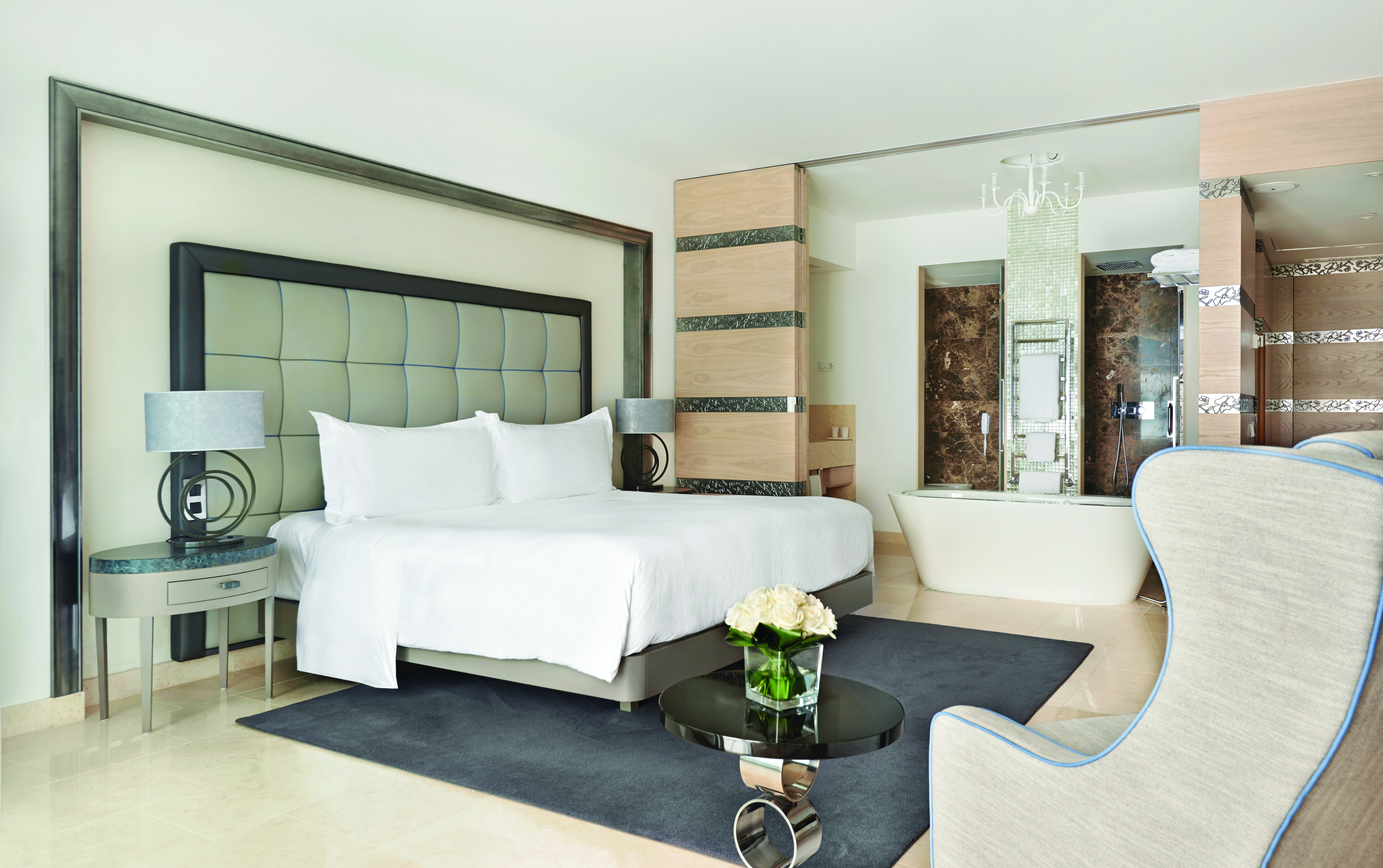 Conrad Algarve grand deluxe room, large bed, armchair, bath, comfortable modern decor