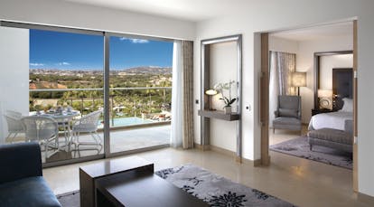 Conrad Algarve grand deluxe suite, bedroom conneted to living area, bright modern decor, balcony with view over pool