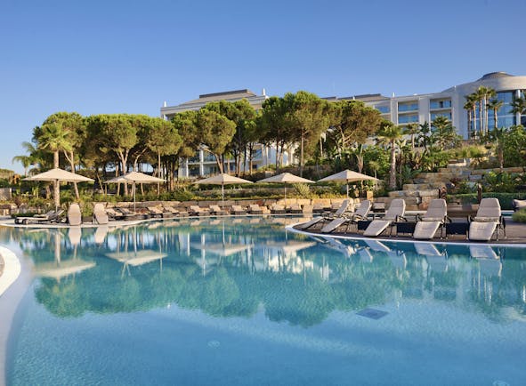 Conrad Algarve swimming pool, sun loungers, trees, outdoor pool