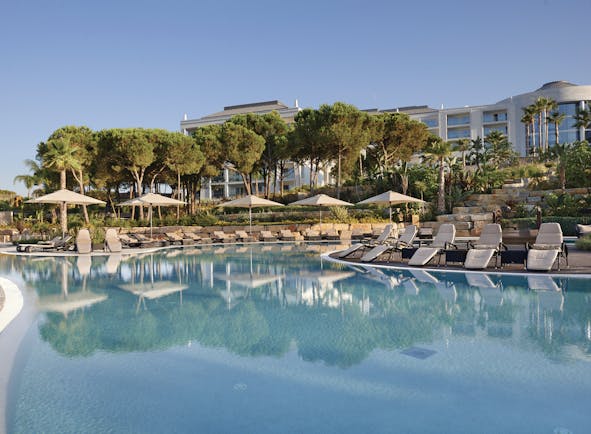 Conrad Algarve swimming pool, sun loungers, trees, outdoor pool