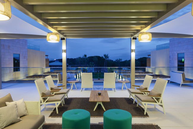 Epic Sana terrace bar on hotel roof, modern chairs and green footstools