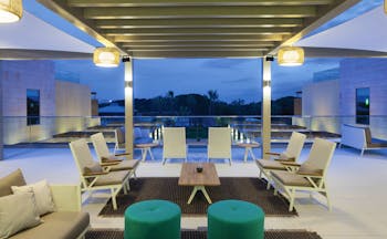 Epic Sana terrace bar on hotel roof, modern chairs and green footstools