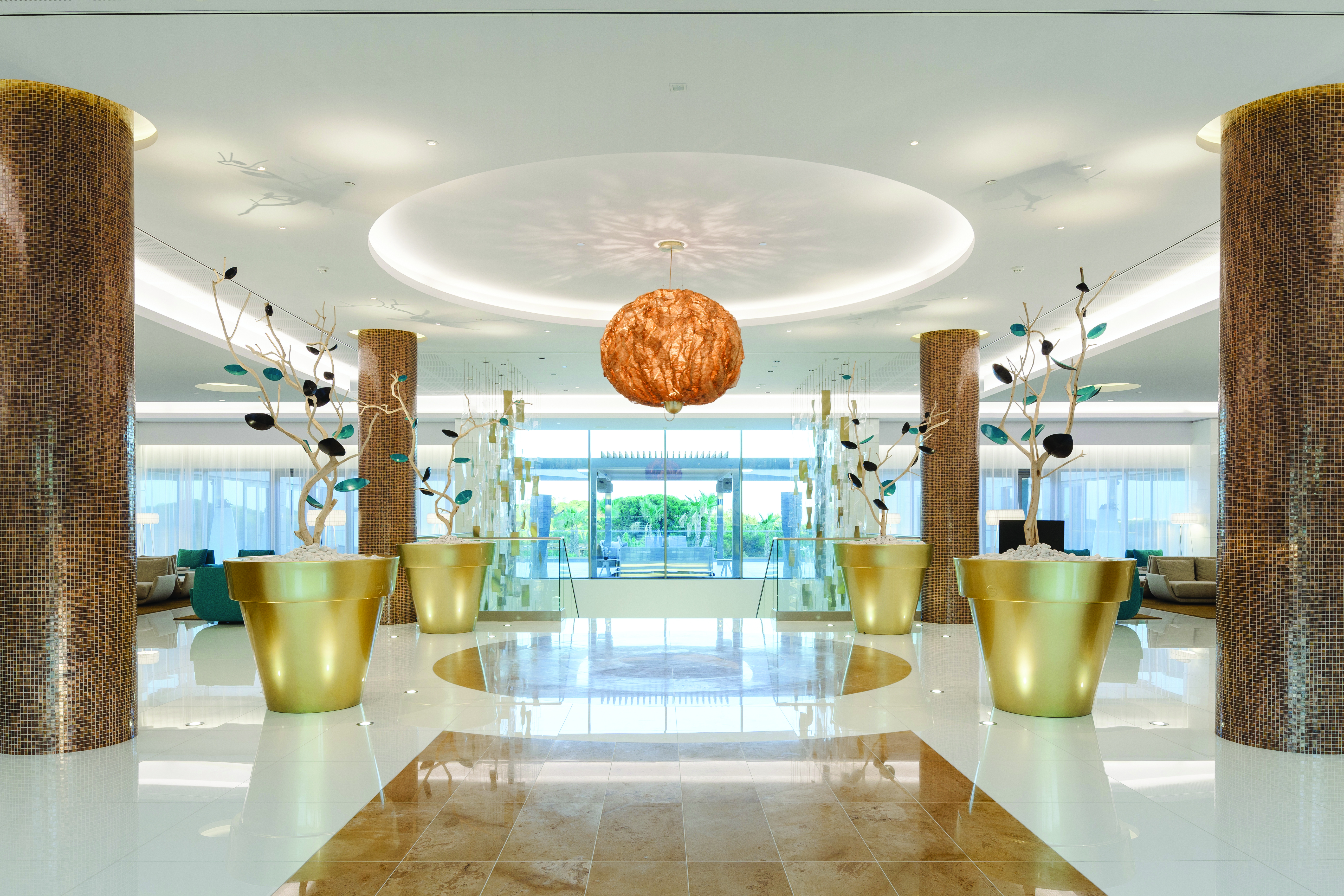 Epic Sana lobby, modern decor, marble floors and columns, colourful flower sculptures