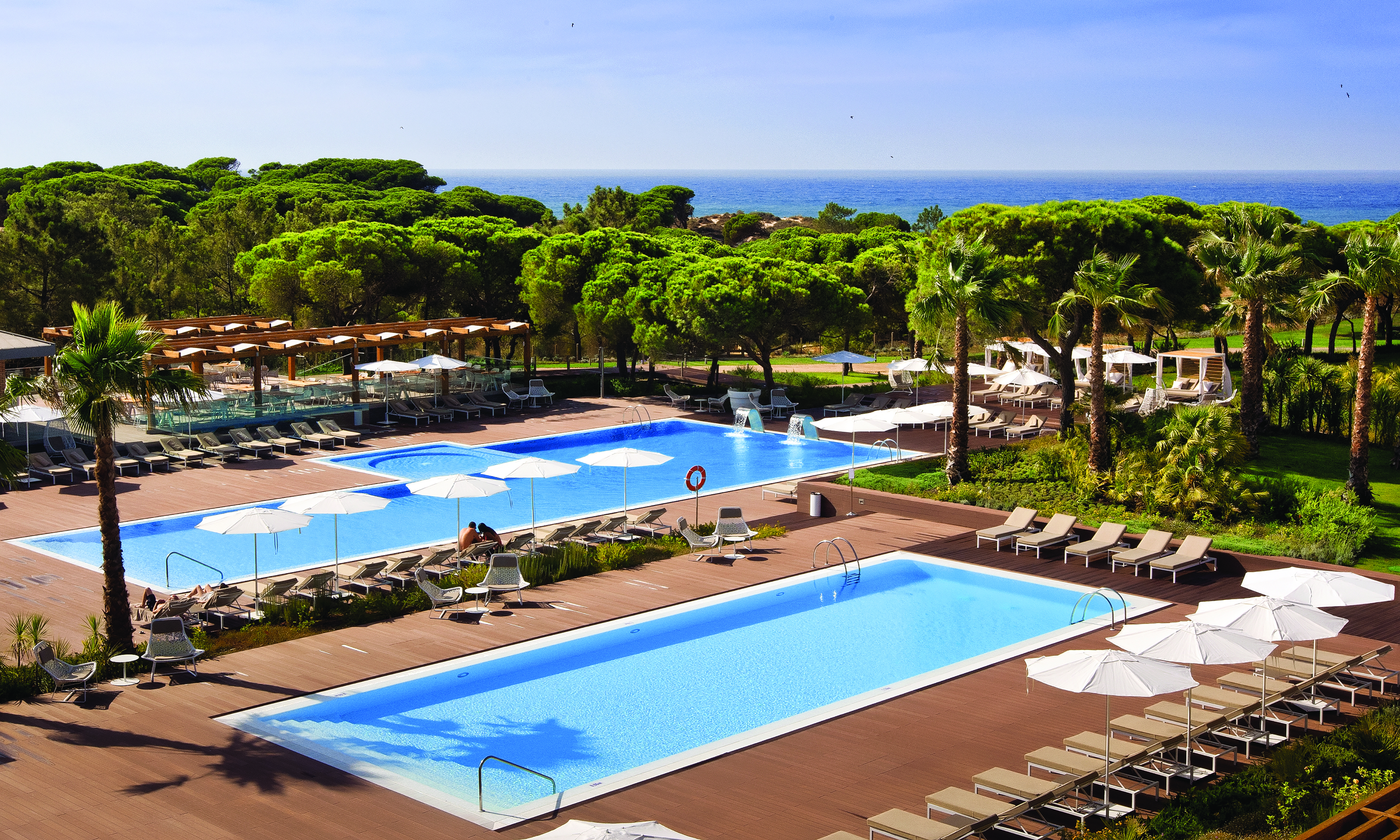 Epic Sana pools, sun loungers and umbrellas, sea in background