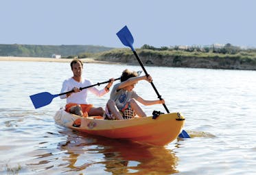 two people in a shared kayak in the sea 