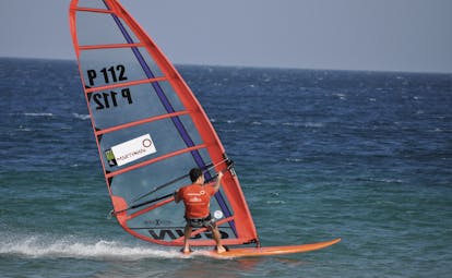a man windsurfing in the sea