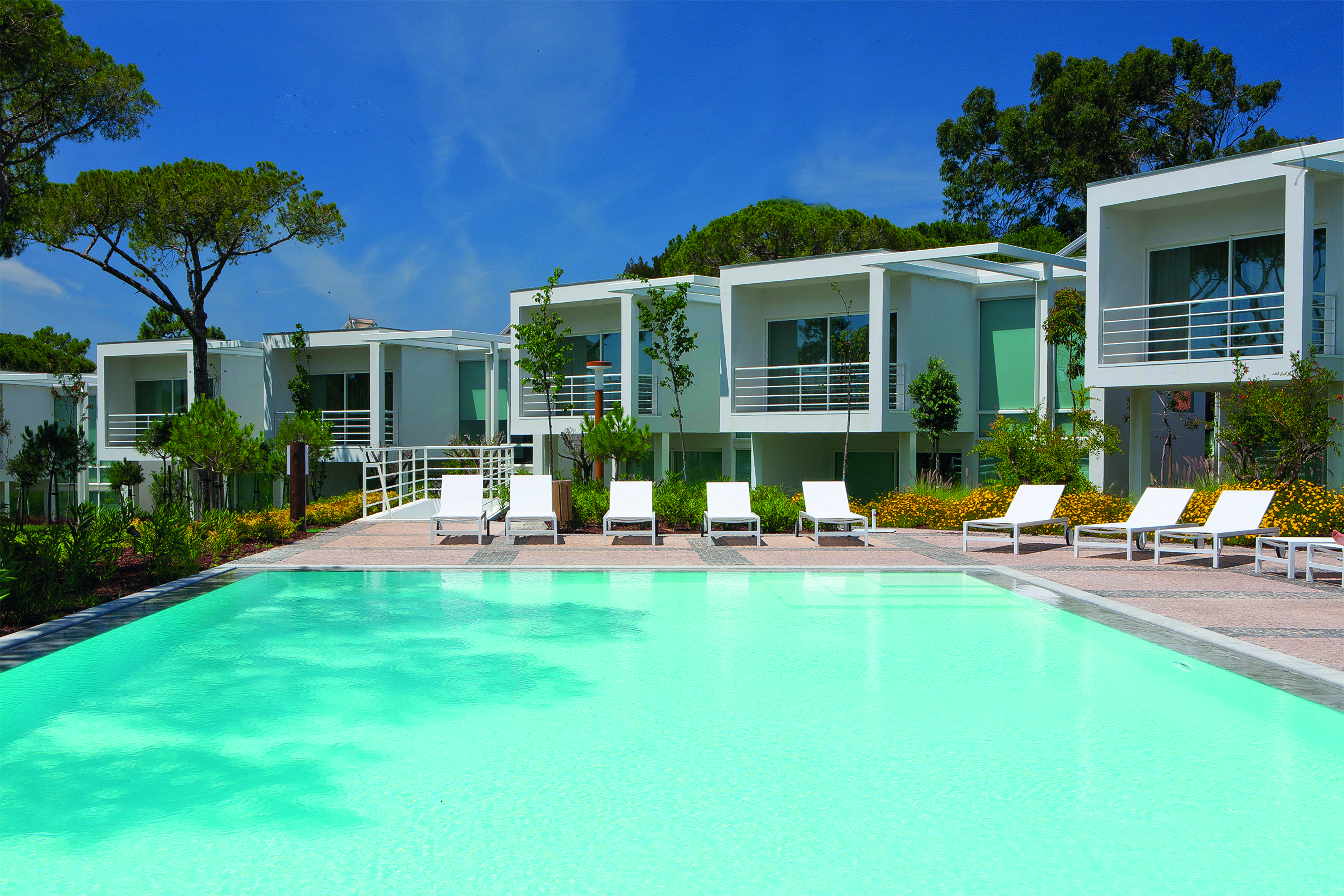 Martinhal Cascais Portugal exterior pool white buildings with balconies overlooking outdoor pool with loungers