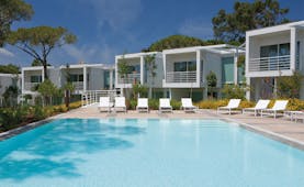 Martinhal Cascais Portugal exterior pool white buildings with balconies overlooking outdoor pool with loungers