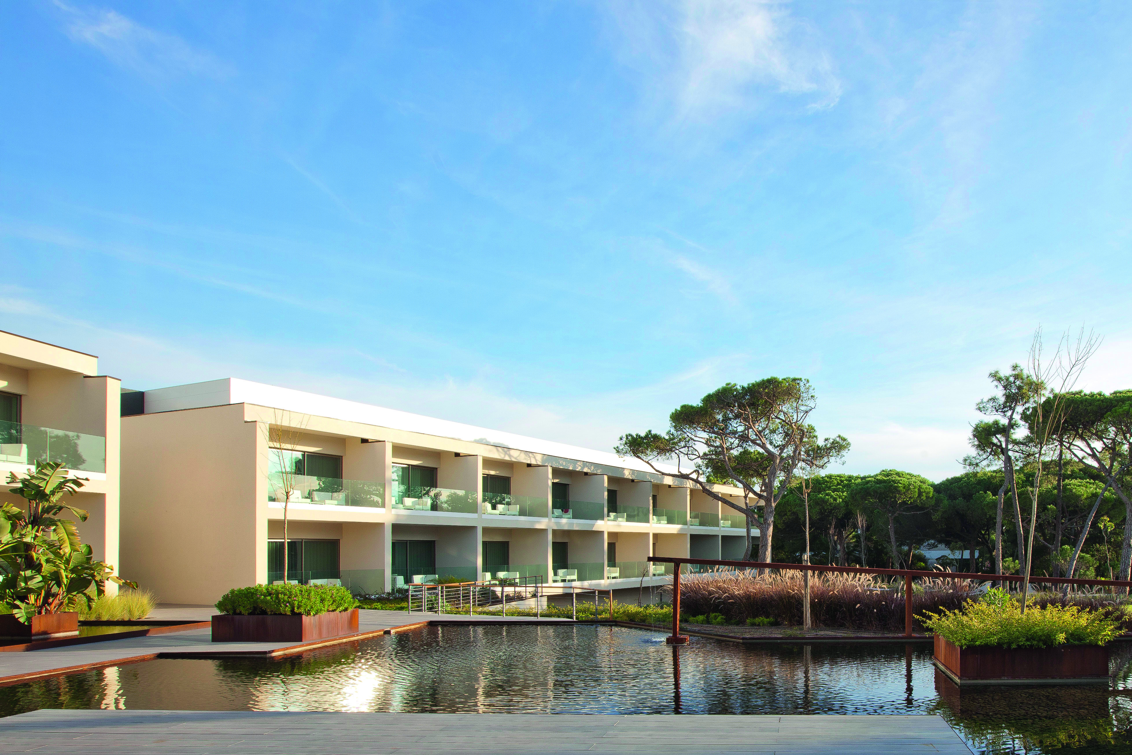 Martinhal Cascais Portugal hotel exterior white buildings with balconies overlooking ponds