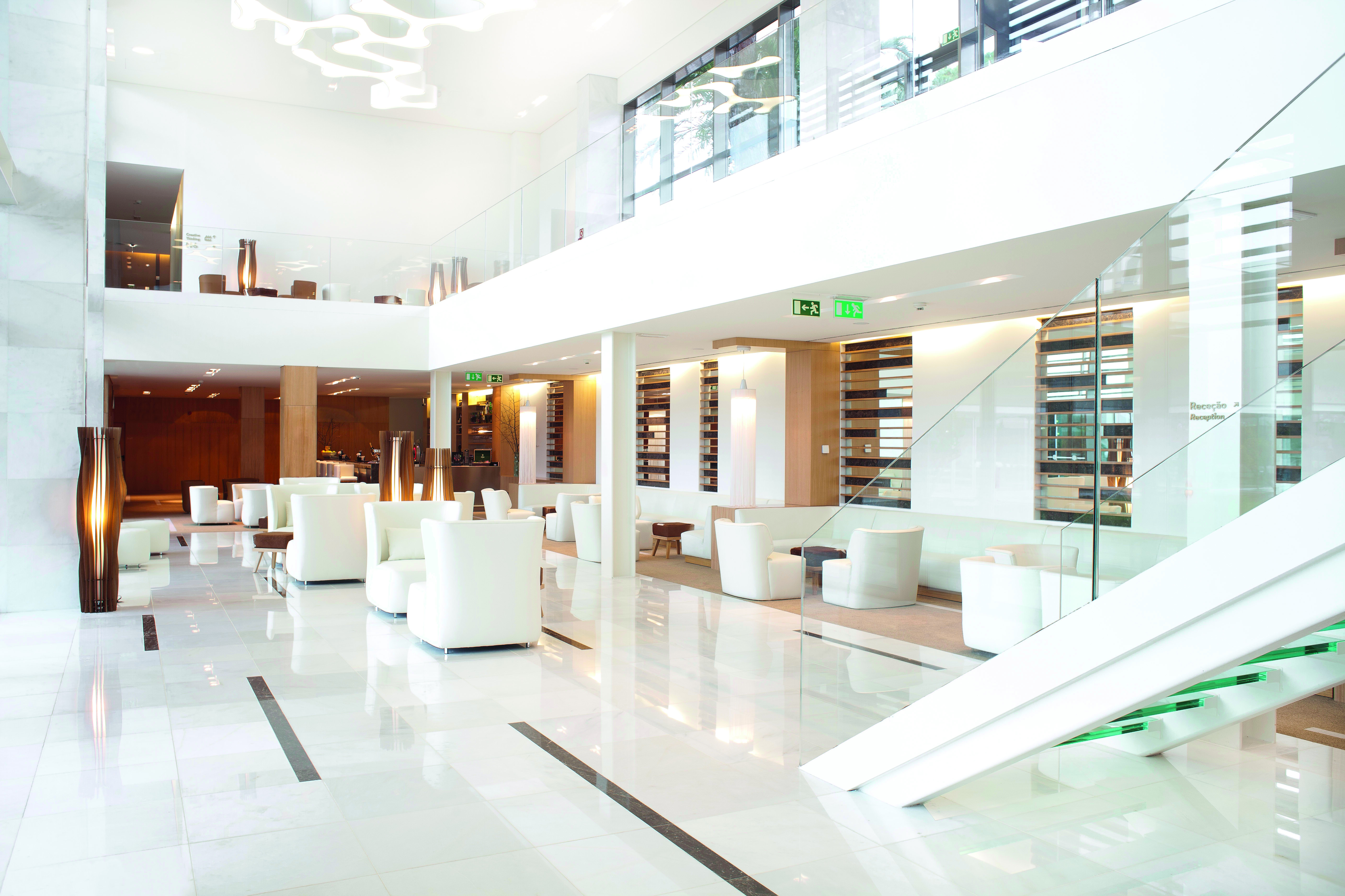 Martinhal Cascais Portugal lobby area with white marble floors and armchairs 