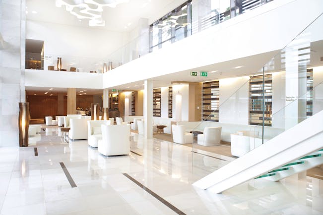 Martinhal Cascais Portugal lobby area with white marble floors and armchairs 