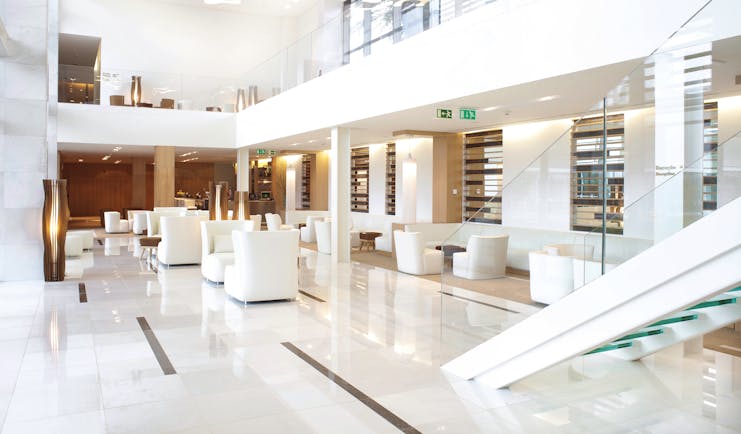 Martinhal Cascais Portugal lobby area with white marble floors and armchairs 