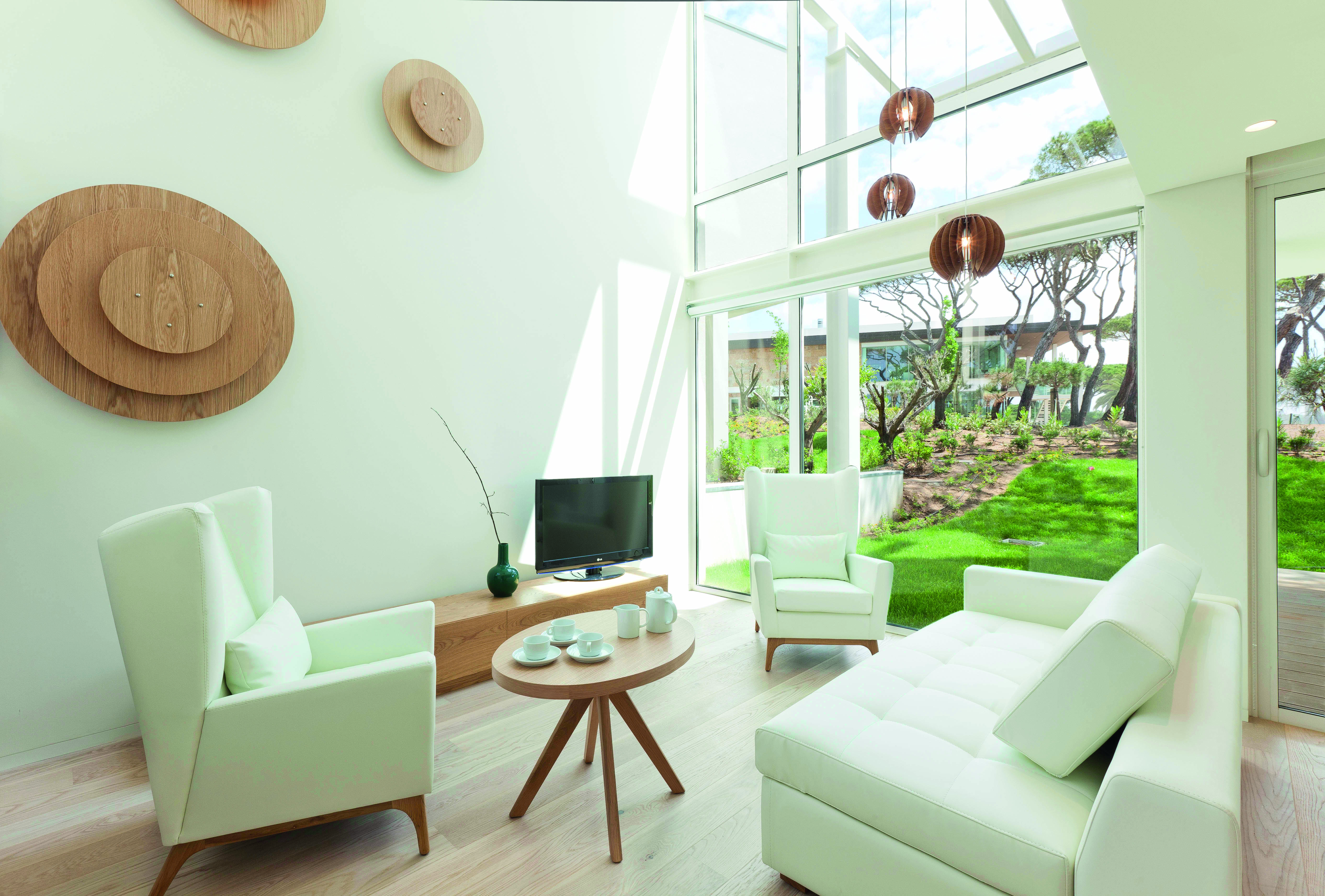 Martinhal Cascais Portugal luxury villa lounge with armchairs and floor to ceiling windows overlooking garden
