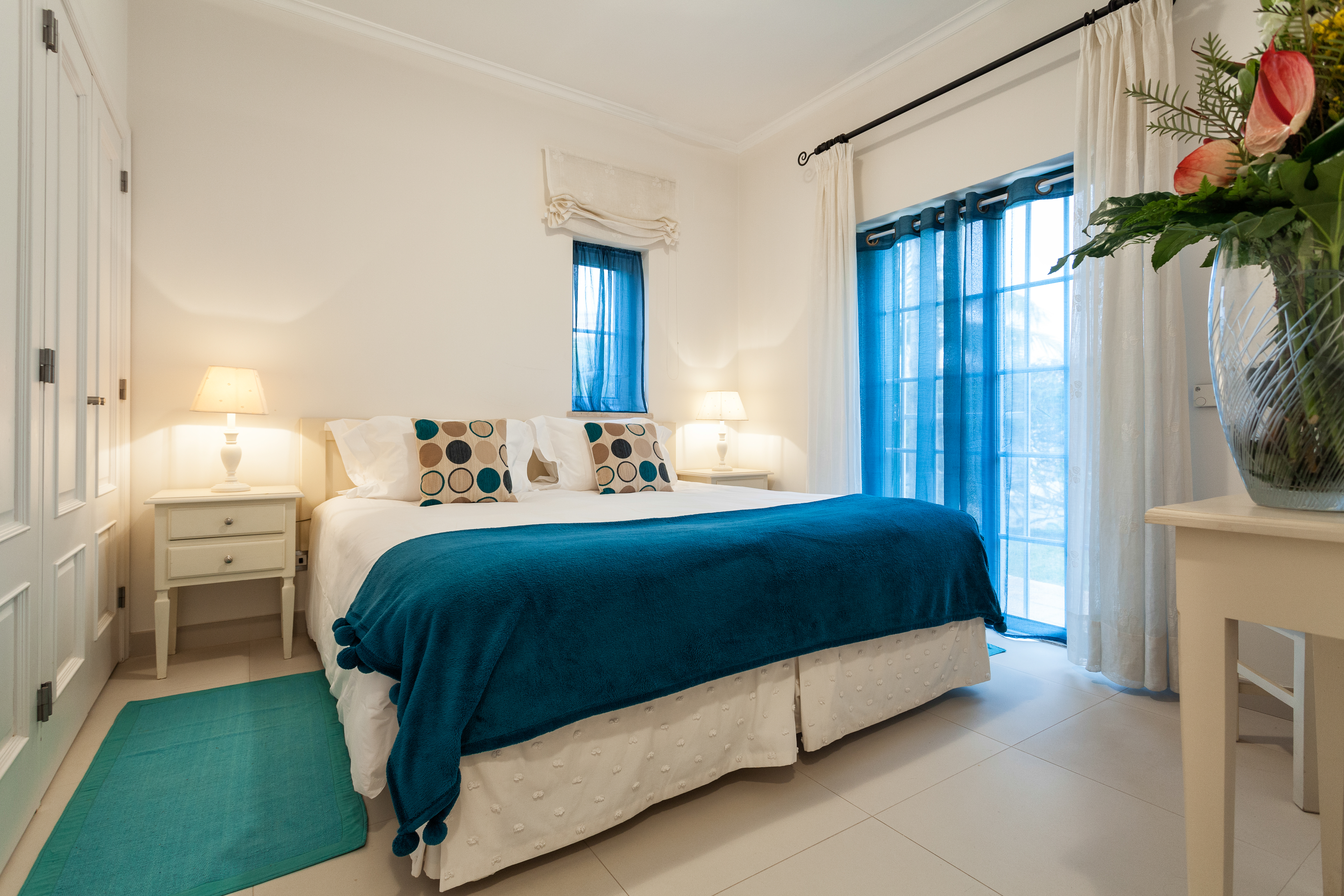 Martinhal Quinta Portugal luxury villa bedroom with bedside table and large windows