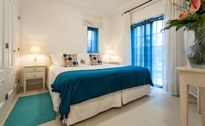 Martinhal Quinta Portugal luxury villa bedroom with bedside table and large windows