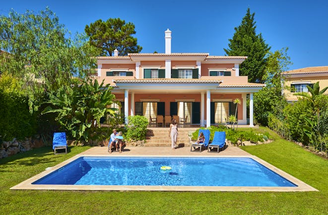 Martinhal Quinta Portugal luxury villa exterior private pool and family sitting in garden