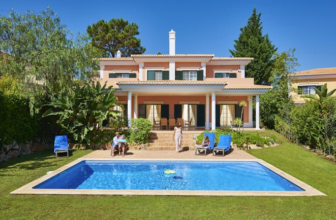 Martinhal Quinta Portugal luxury villa exterior private pool and family sitting in garden