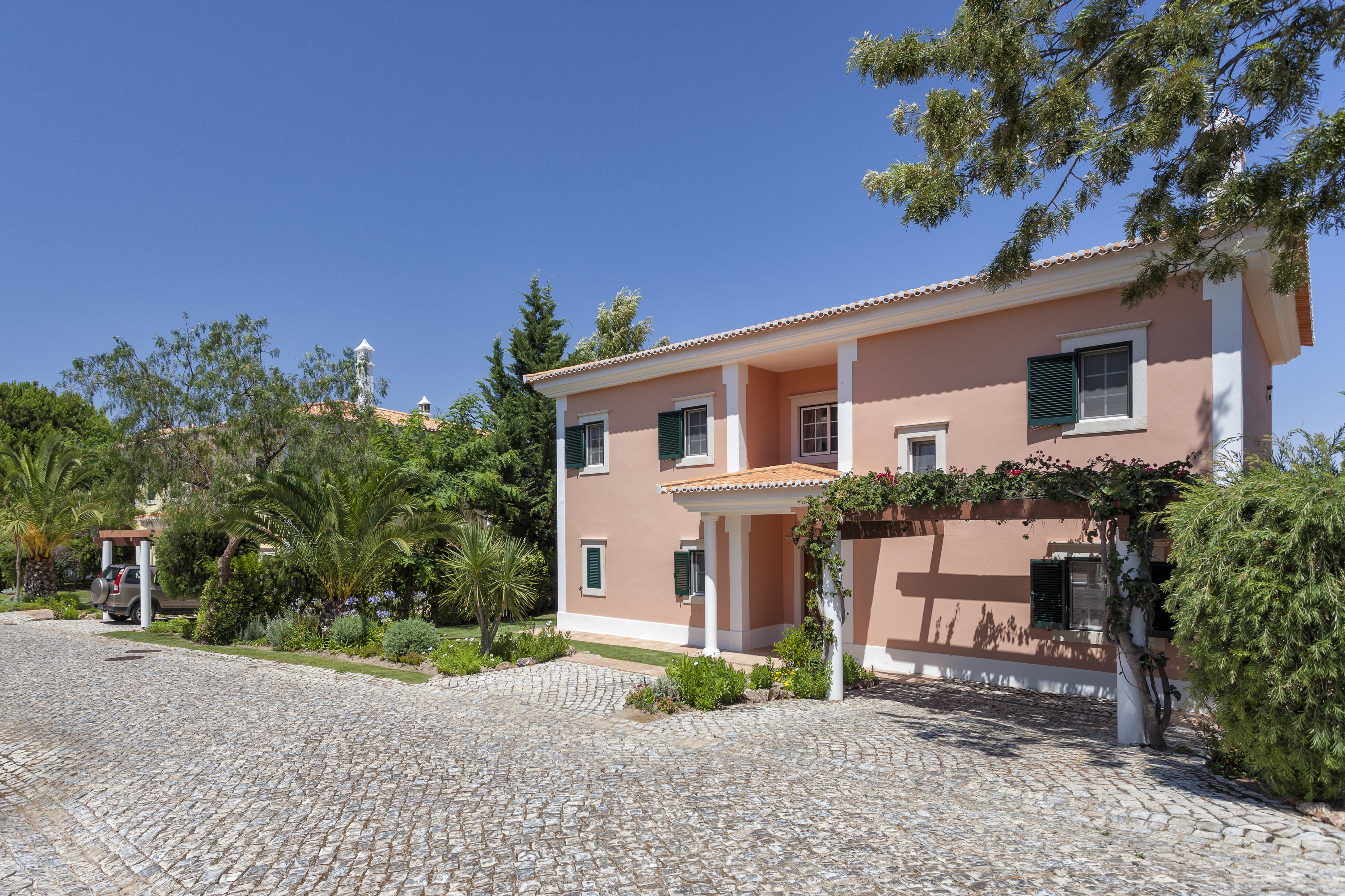 Martinhal Quinta Portugal luxury villa with stone pathway and palms