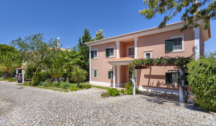 Martinhal Quinta Portugal luxury villa with stone pathway and palms