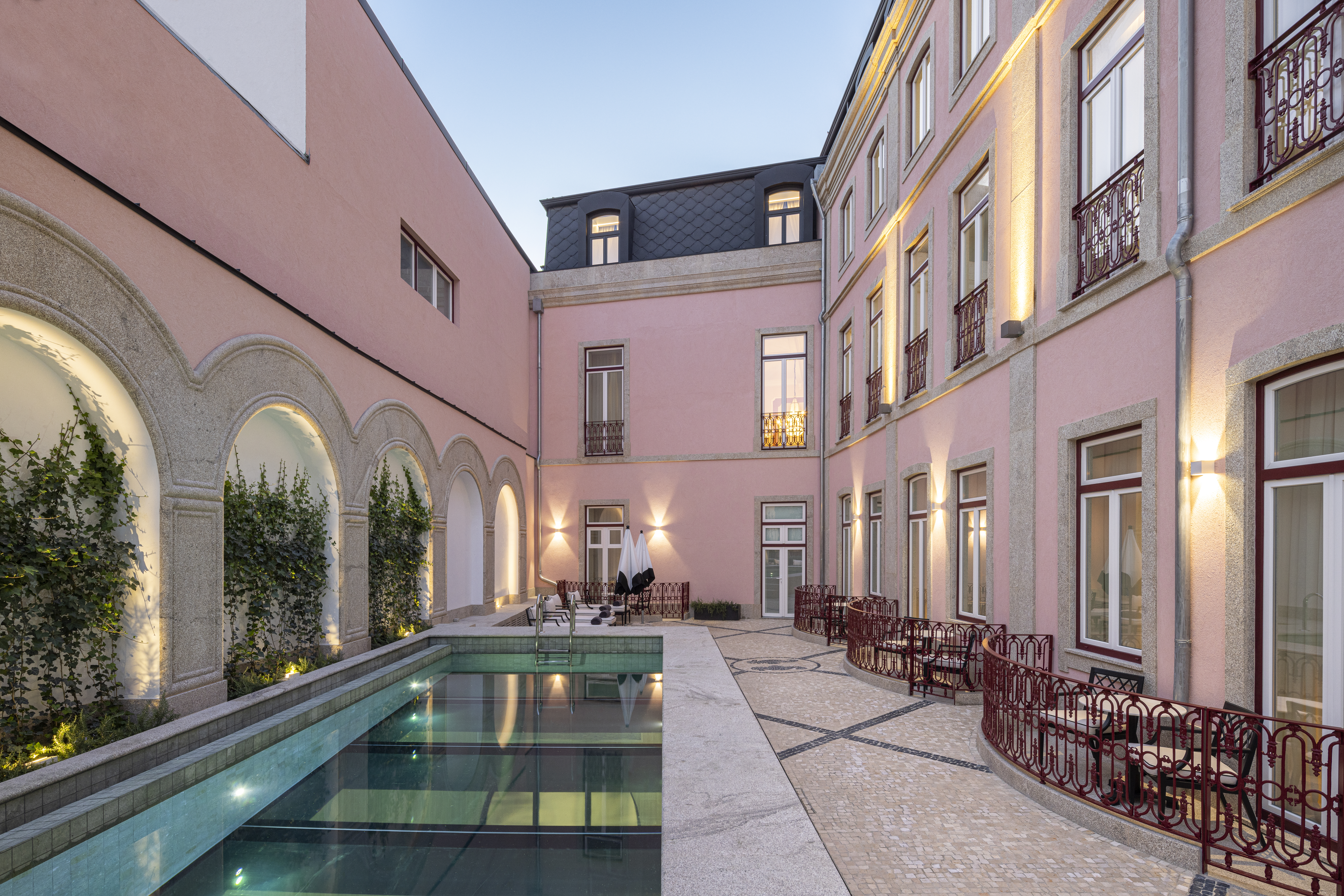 Palacete de Valdemouro poolside, showing small sitting areas for ground floor rooms beside the pool