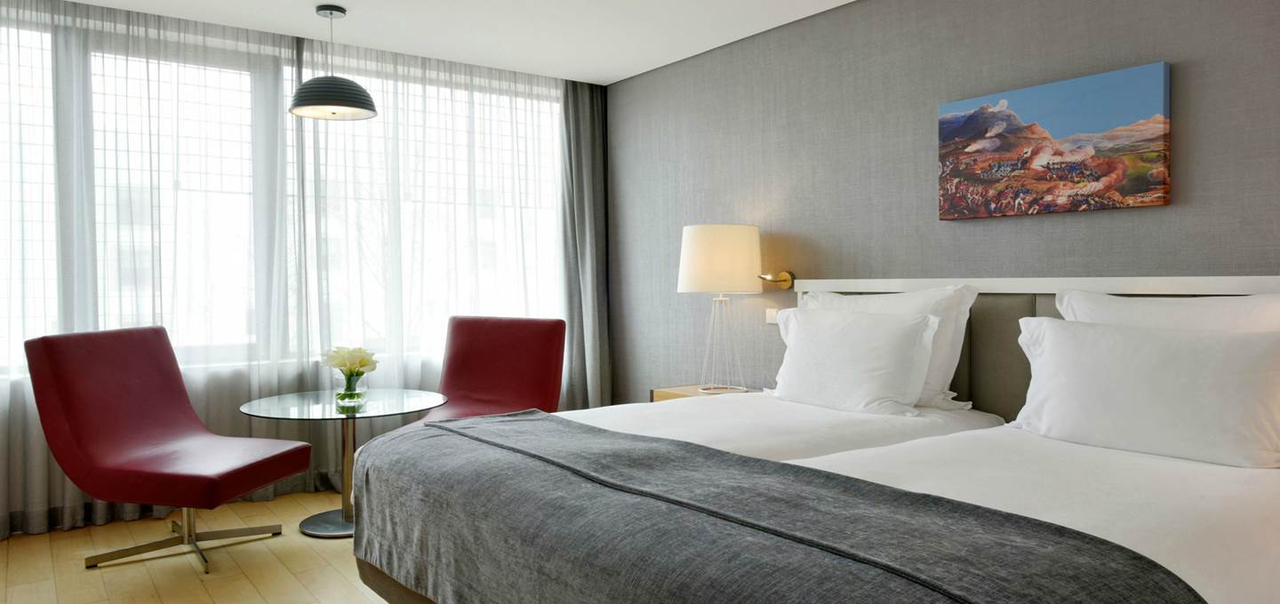 Pestana Cidadela Cascais classic room, double bed, modern chairs, artwork on wall
