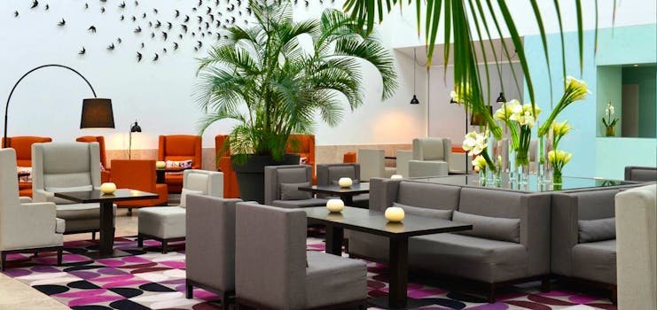 Pestana Cidadela Cascais lobby, modern armchairs, bright colours, bird wall art installation