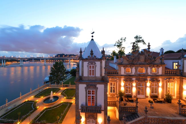 Pestana Palacio do Freixo grounds, hotel building and courtyard at twilight, hotel gardens overlooking river