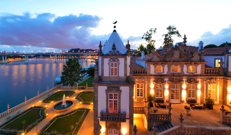 Pestana Palacio do Freixo grounds, hotel building and courtyard at twilight, hotel gardens overlooking river
