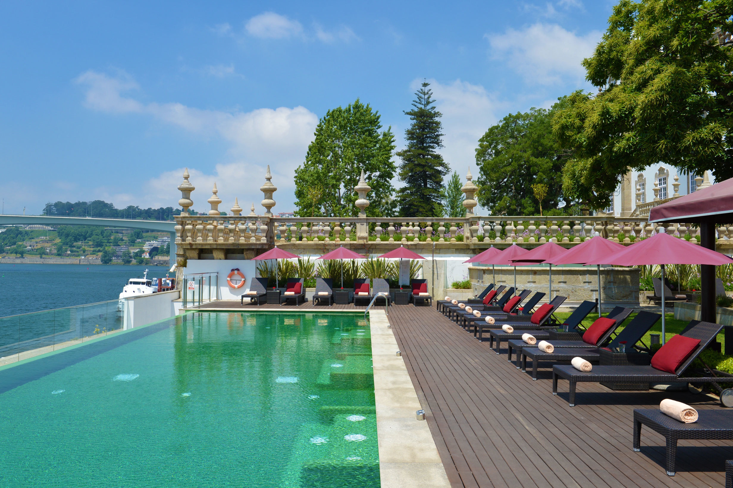 Pestana Palacio do Freixo pool, overlooking river, sun loungers with parasoles