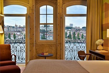 Pestana Vintage Porto grand view room, double bed, historic walls leading to balcony