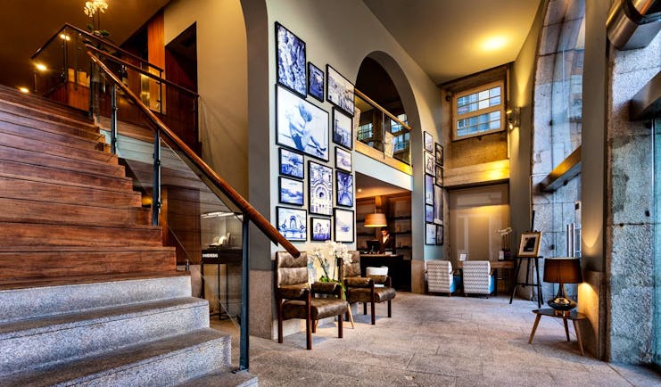 Pestana Vintage Porto lobby, large staircase, historic architecture, armchairs, stone floor