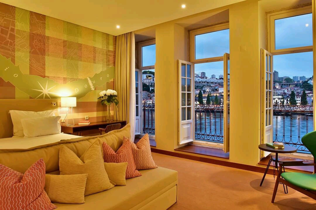 Pestana Vintage Porto river view room, double bed, french windows leading to balcoy, views over river