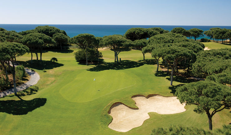 Pine Cliffs Portugal golf course with trees and sea view