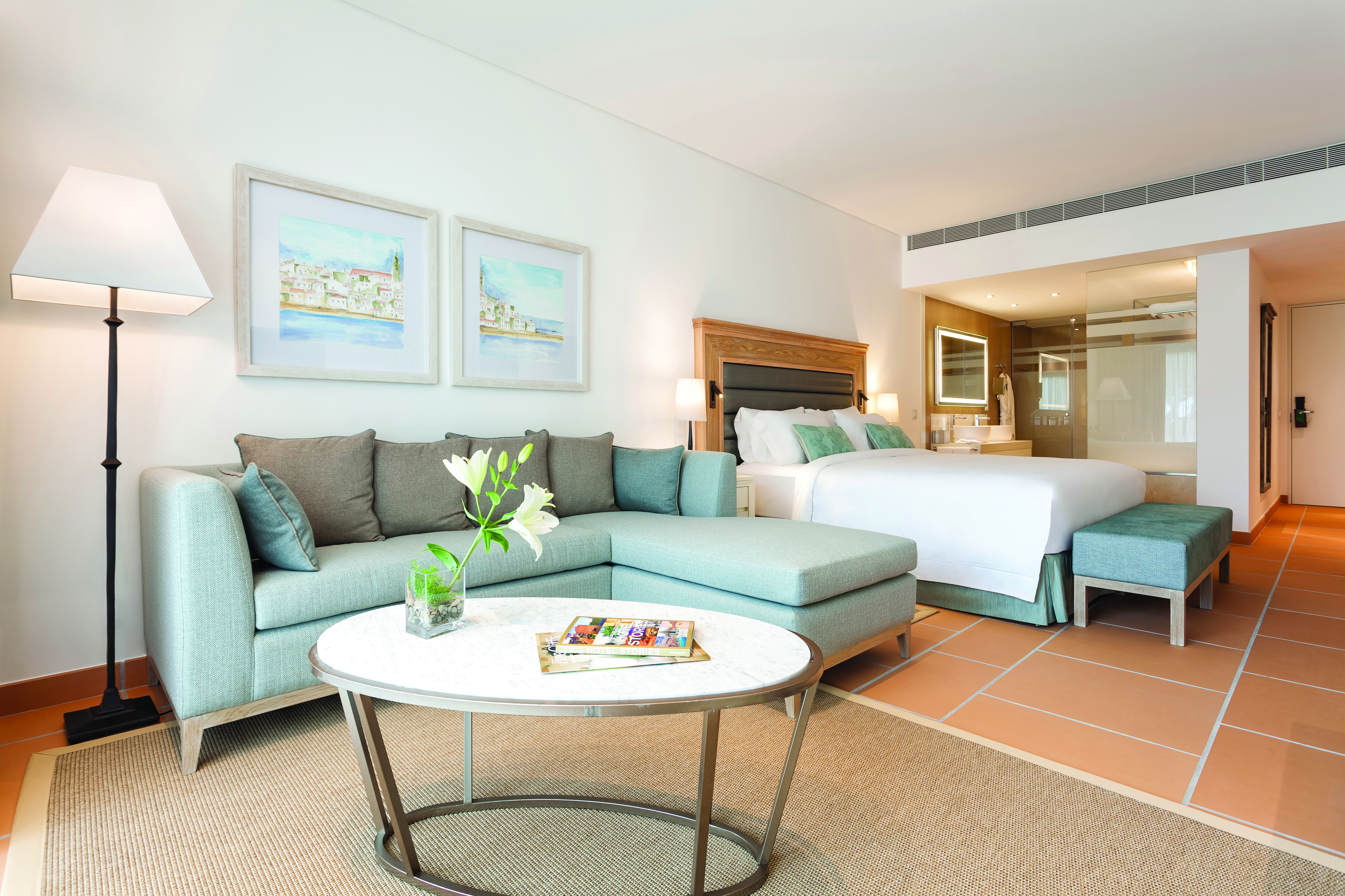 Pine Cliffs Portugal Ocean Suite open plan suite with bed and sitting area with sofa