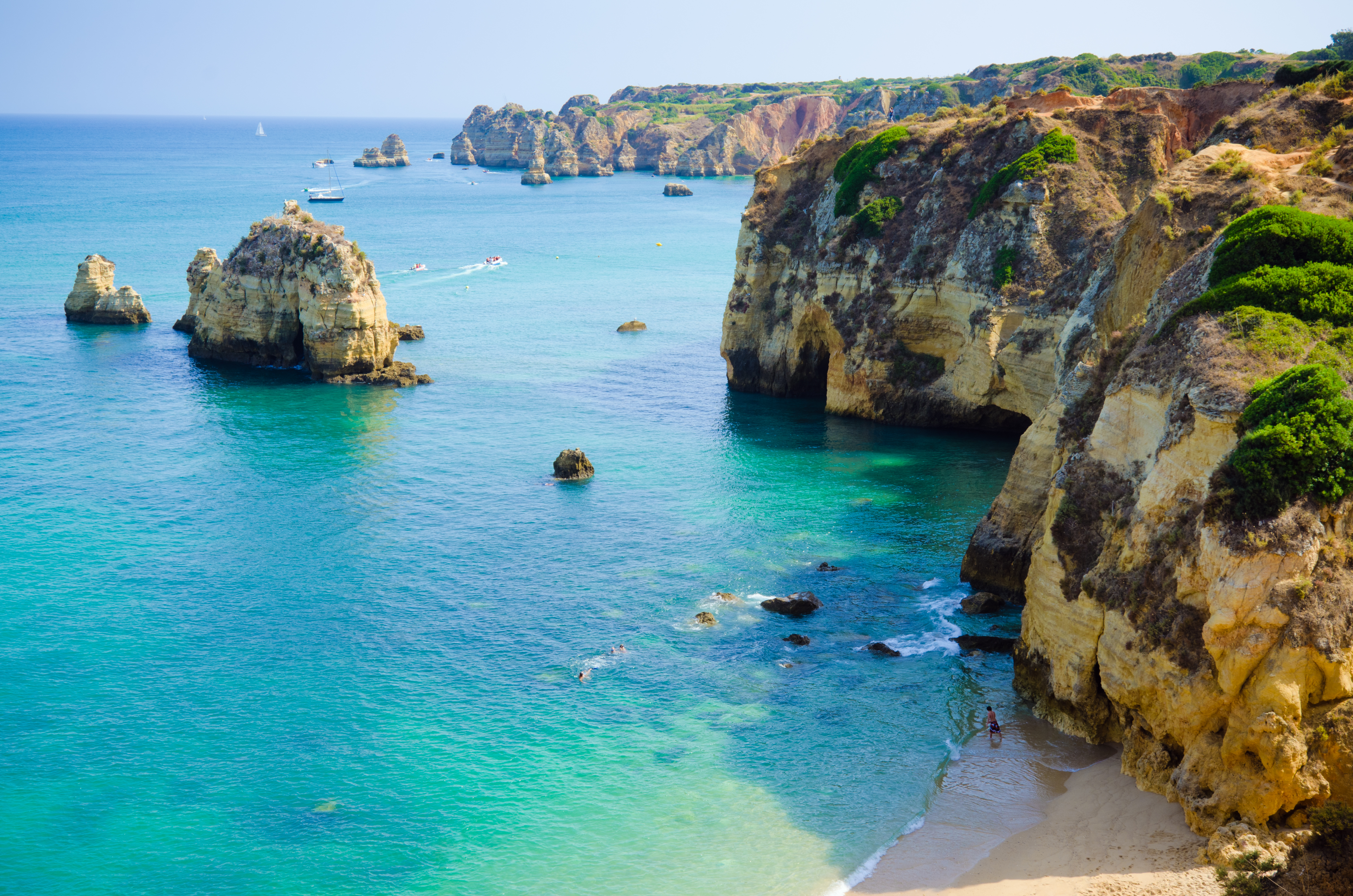Lagos shoreline in the Algarve, cliffs, rock formations, bright blue sea