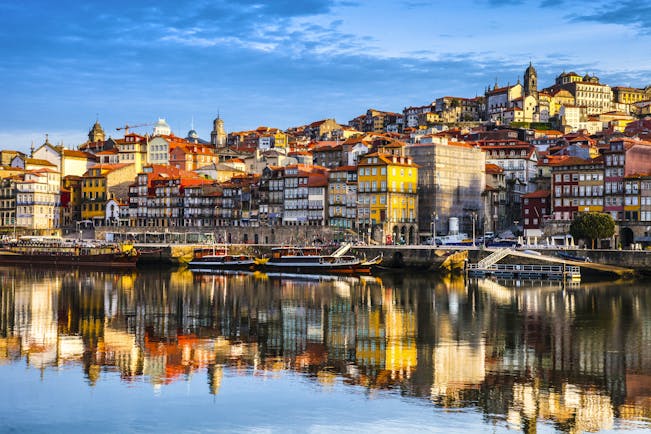 Porto Ribeira in Portugal, colourful houses reflected in the water of the Douro River