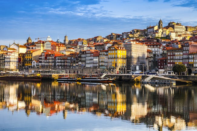Porto Ribeira in Portugal, colourful houses reflected in the water of the Douro River