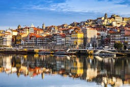Porto Ribeira in Portugal, colourful houses reflected in the water of the Douro River