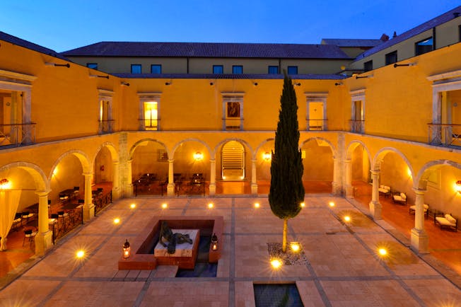 Pousada Convento de Tavira courtyard at sunset, colonnaded cloisters